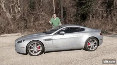Man In Green Shirt Next To Silver Sports Car GIF