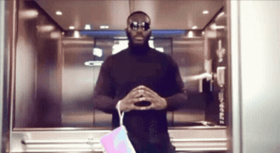 Man In Green Shirt Next To Silver Sports Car GIF