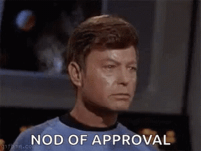 Man In Green Shirt Nods Approval GIF