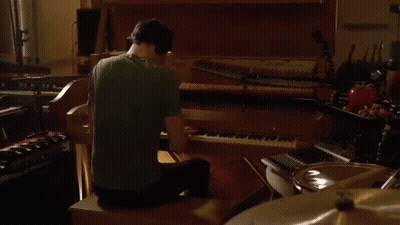 Man In Green Shirt Playing Piano GIF