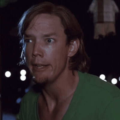 Man in Green Shirt Saying Say What