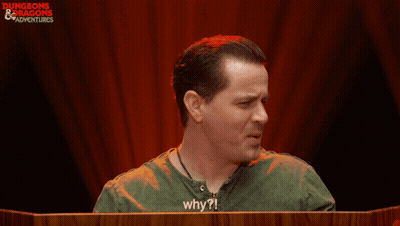 Man In Green Shirt Saying Why In Front Of Red Curtain GIF
