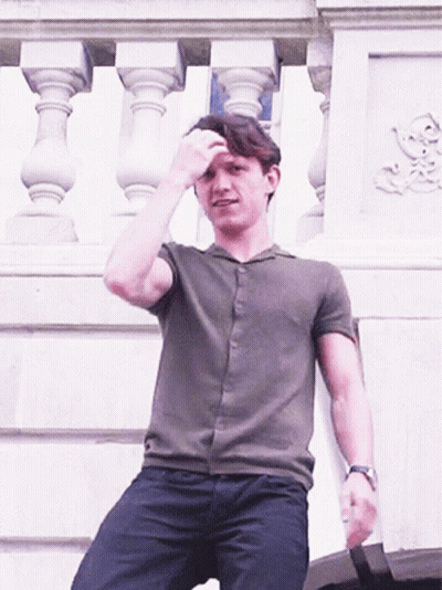 Man In Green Shirt Sitting On Balcony GIF