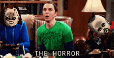 Man In Green Shirt Sitting On Couch With Two Dolls Saying The Horror GIF