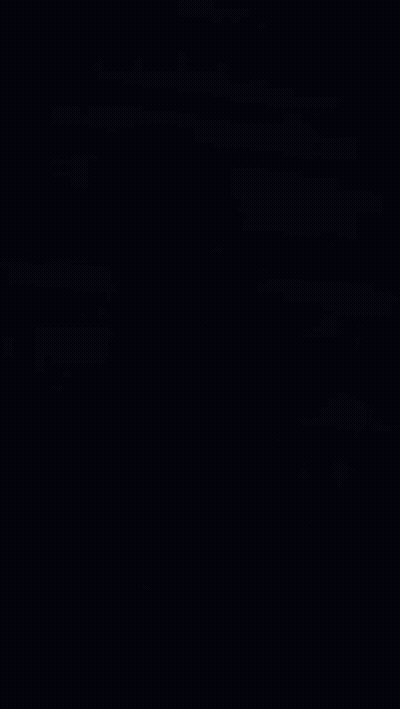 Man In Green Shirt Sitting On Ground Looking At Phone And Smiling GIF