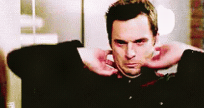 Man In Green Shirt Smiling At Man In Red GIF