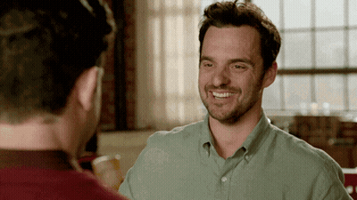 Man In Green Shirt Smiling At Man In Red Shirt GIF