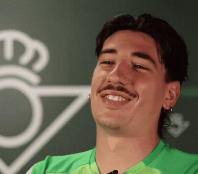 Man In Green Shirt Smiling In Front Of Crown GIF