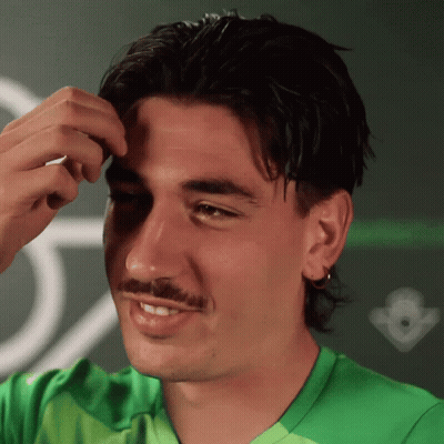 Man In Green Shirt Smiling In Front Of Crown GIF