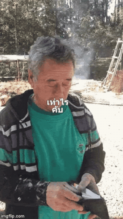 Man In Green Shirt Smoking Cigarette Holding Wallet GIF