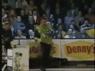 Man In Green Shirt Standing In Front Of Denny's Sign GIF