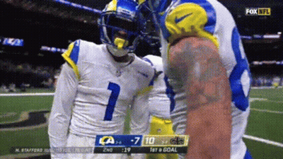 Man In Green Shirt Standing In Front Of Ohhhhhhh Sign GIF