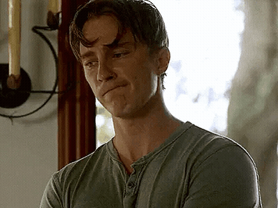 Man In Green Shirt Standing In Front Of Window With Candle GIF