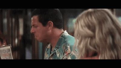 Man In Green Shirt Talking To Woman Over Menu GIF