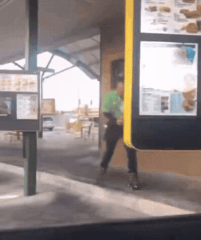 Man In Green Shirt Walking Through Drive-Thru GIF