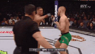 Man In Green Shorts Kicking Opponent GIF