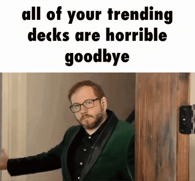 Man In Green Suit And Glasses Standing Before Wooden Door GIF