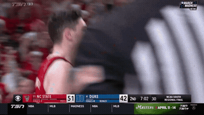 Man In Green Suit And Hat On Stage With NCAAF Sign GIF
