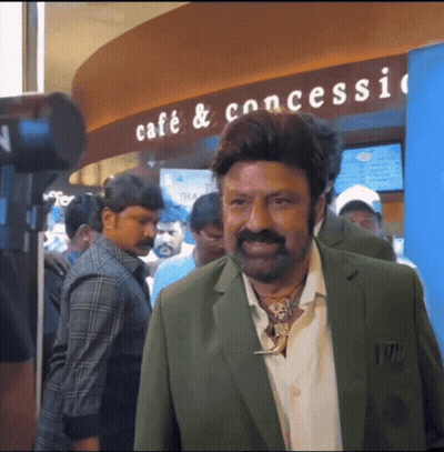 Man In Green Suit By Cafe Sign GIF