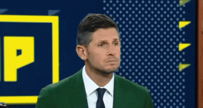 Man In Green Suit Standing Beside P Sign GIF