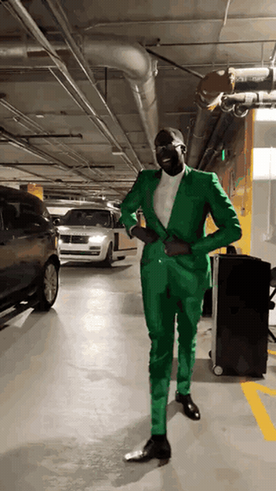 Man In Green Suit Standing In Garage GIF