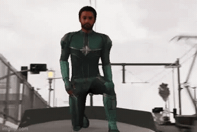 Man In Green Superhero Costume Kneeling On Bridge GIF