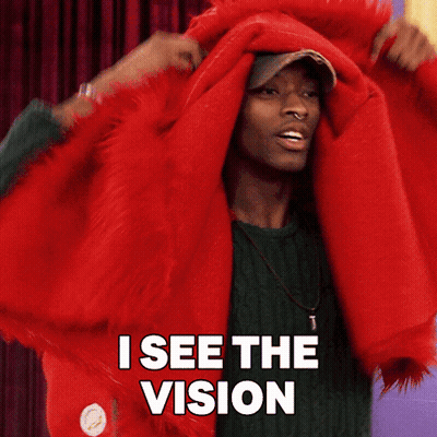 Man In Green Sweater Covering Head With Red Blanket Says I See The Vision GIF