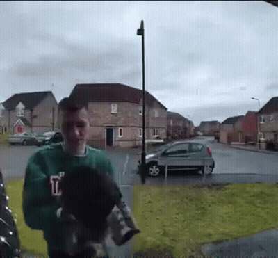 Man In Green Sweater Holding Dog GIF