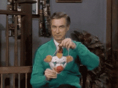 Man In Green Sweater Holding Stuffed Animal GIF