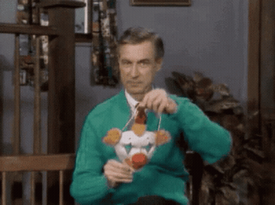 Man In Green Sweater Holding Toy Chicken GIF