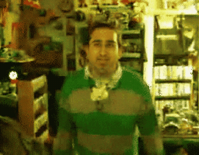 Man In Green Sweater In Store GIF