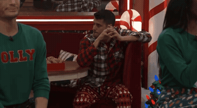Man In Green Sweater Saying Holly In Booth GIF