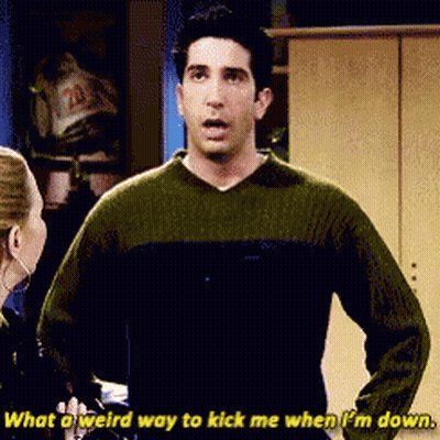 Man In Green Sweater Says What A Weird Way To Kick Me When I'm Down GIF