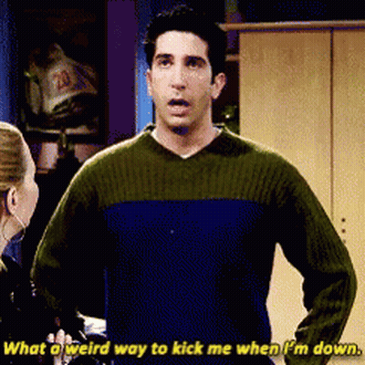 Man In Green Sweater Says What A Weird Way To Kick Me When I'm Down GIF