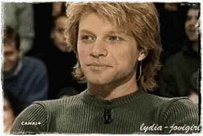 Man In Green Sweater Sitting In Front Of Crowd Canal+ GIF