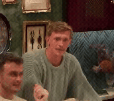 Man In Green Sweater Talking To Another Man GIF