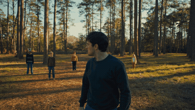 Man In Green Sweater With Three Children In Forest GIF