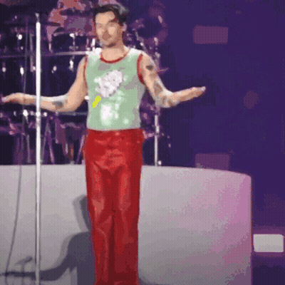 Man In Green Tank Top And Red Pants At Microphone GIF