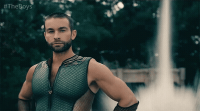 Man In Green Tank Top In Front Of Waterfall GIF