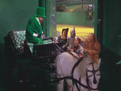 Man In Green Top Hat Pulling Carriage GIF