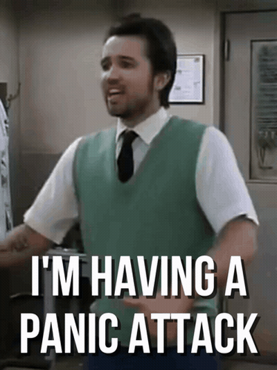 Man In Green Vest And Tie Saying Panic Attack GIF