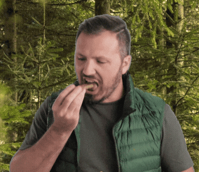 Man In Green Vest Eating Food GIF