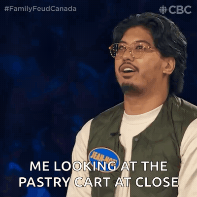Man In Green Vest Looking At Pastry Cart GIF