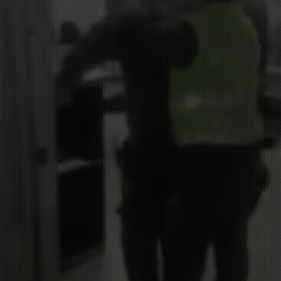 Man In Green Vest Next To Man In Black Shirt GIF