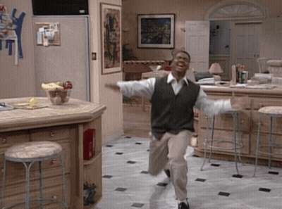 Man In Green Vest Running In Kitchen With Stools GIF