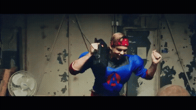 Man In Green Wig And Purple Hat In Front Of Mirror GIF