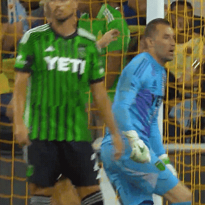 Man In Green Yeti Jersey Next To Man In Blue Jersey GIF