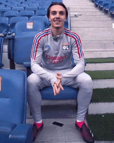Man In Grey Emirates Fly Better Shirt Sitting In Stadium GIF