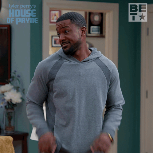 Man In Grey Hoodie In Front Of Tyler Perry's House Of Payne Wall GIF