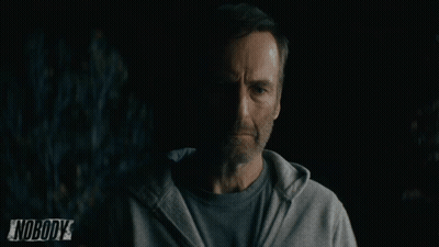 Man In Grey Hoodie Standing In Front Of Nobody Sign GIF